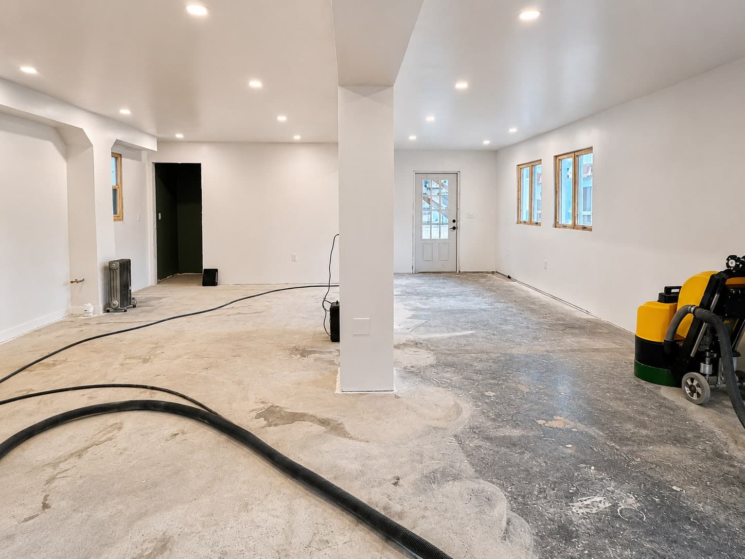 Bare concrete floor being diamond-ground and cleaned ahead of an epoxy installation